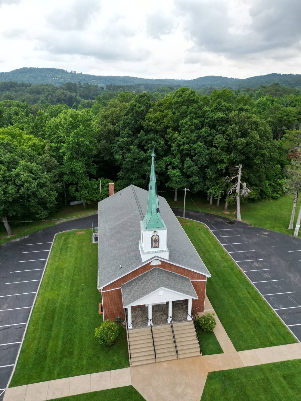 Aerial view of a country church and its paved parking lot