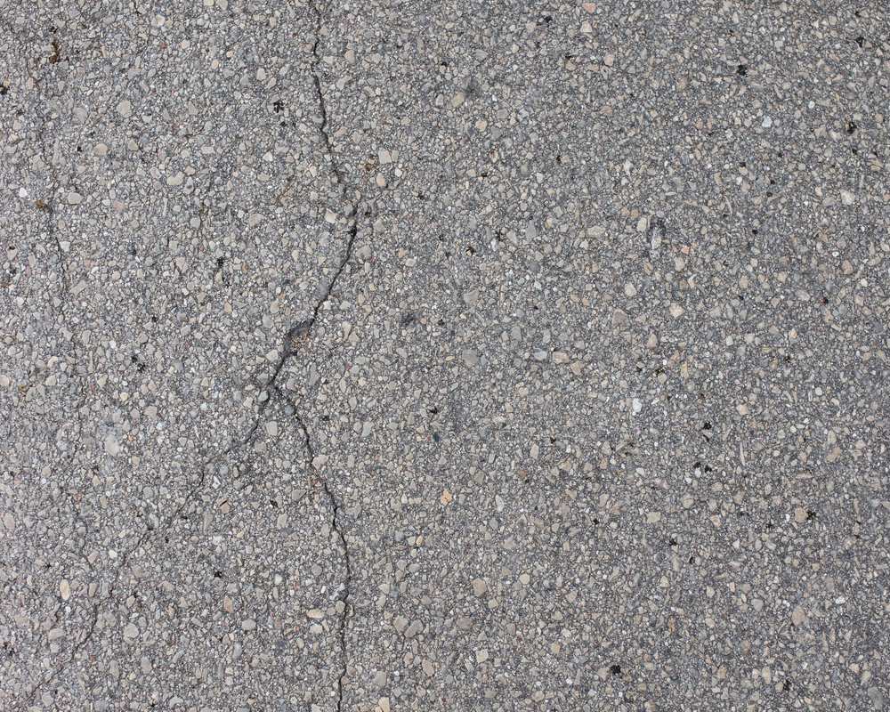 Worn, cracked grey asphalt